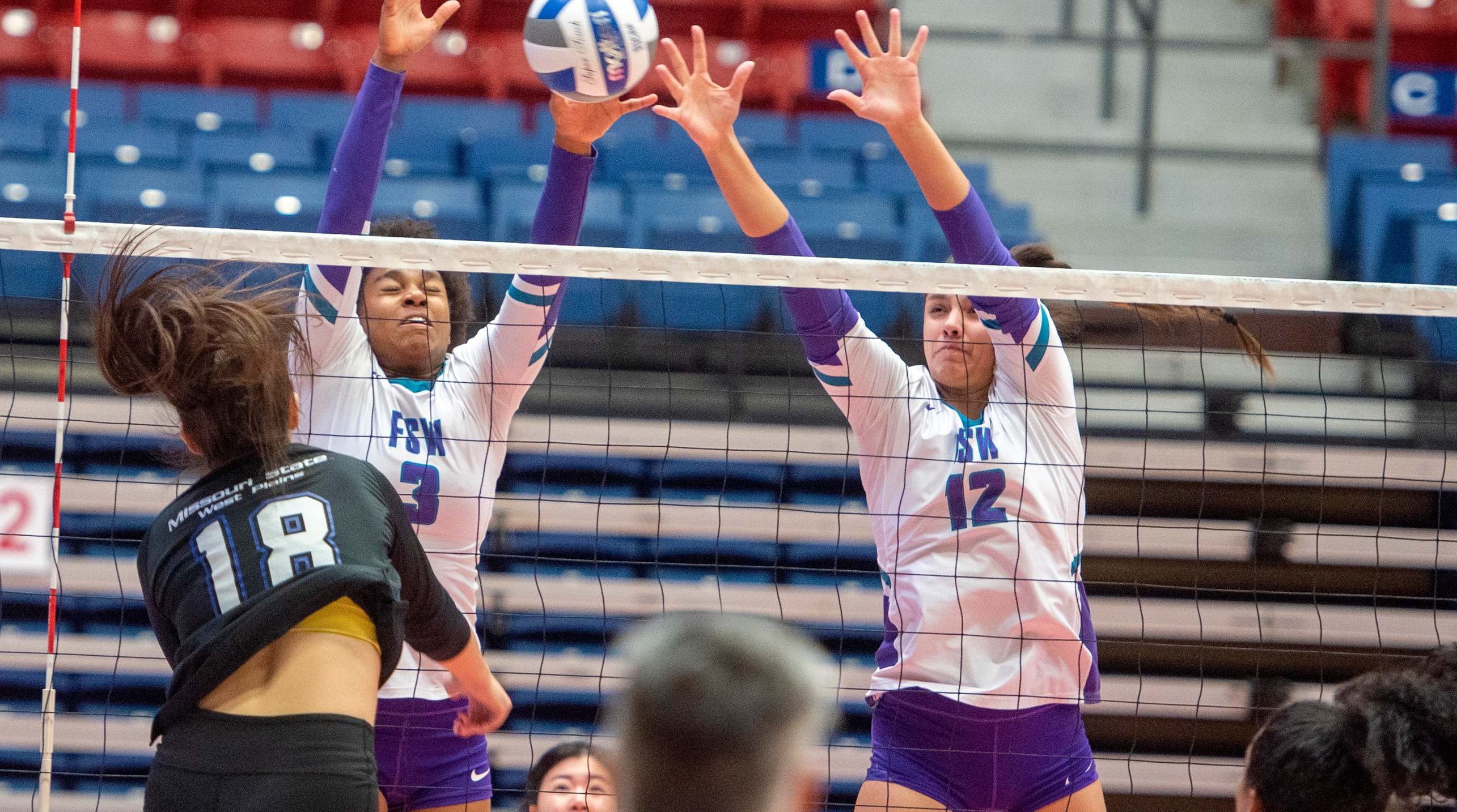 Maria Cecilia and Julia Lawrenz go up for a block in the Bucs NJCAA National Tournament match against Missouri State-West Plains (Photo by Andy Carpenter)